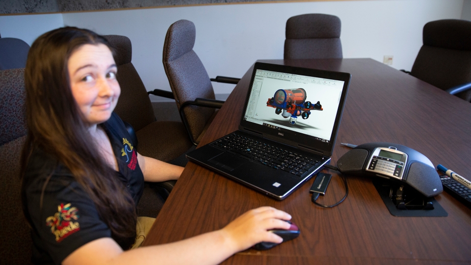 woman showing robotics design on computer