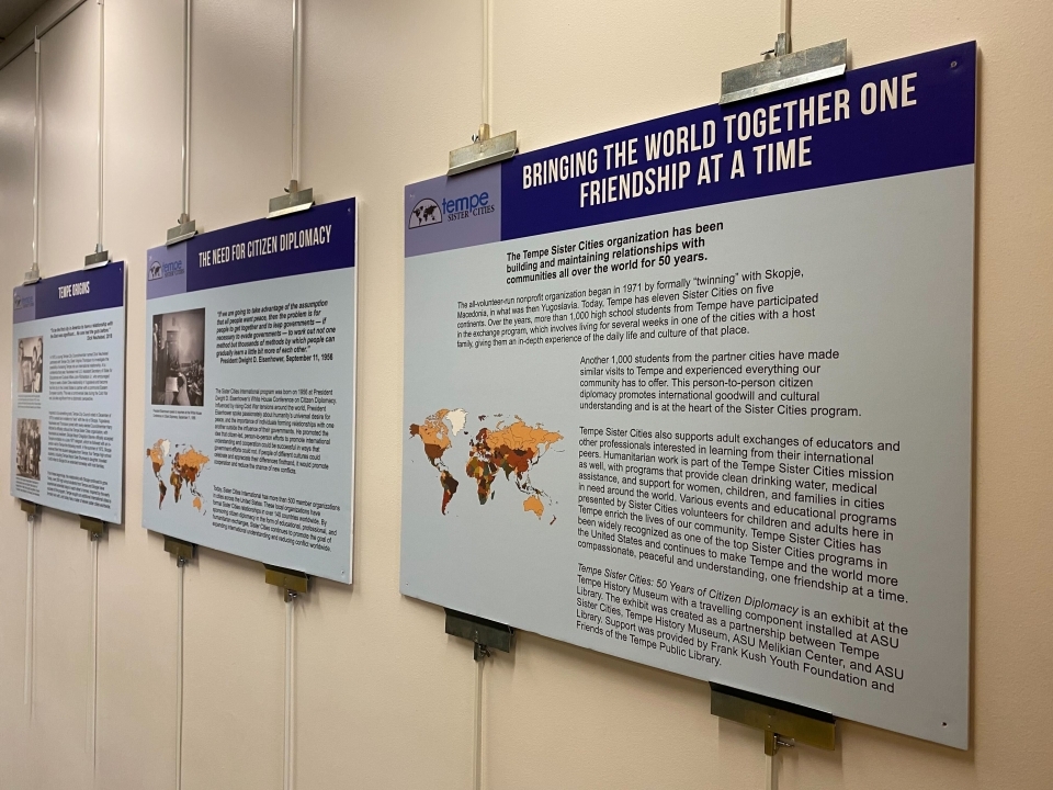 Exhibit panels with text about cities in the Tempe Sister Cities program hanging on a wall.