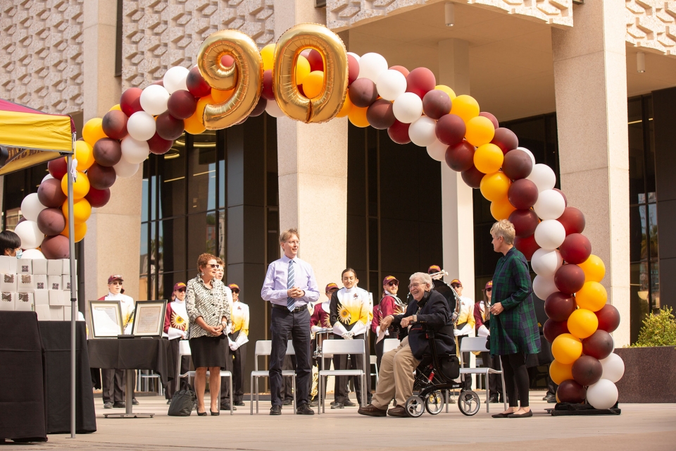 people under a ballon arch for a birthday celebration at ASU