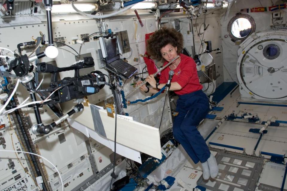 Astronaut Cady Coleman plays a flute in space
