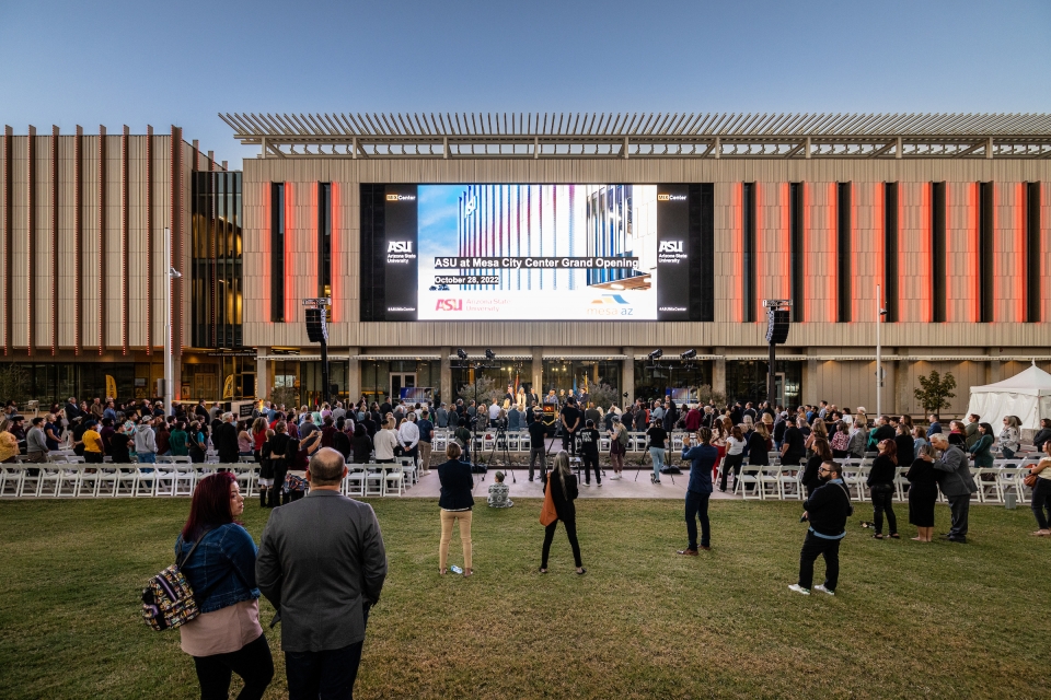 Outside of ASU MIX Center building featuring a large screen
