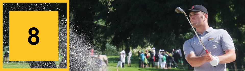Golfer hits a ball into the air.