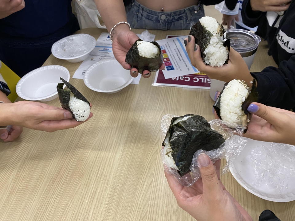 Students hold their completed onigiri