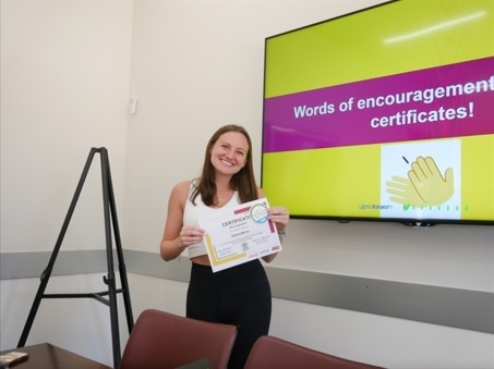 ASU student Selena Morse smiles and holds a certificate showing completion of training for the ASU Eco Reps program.