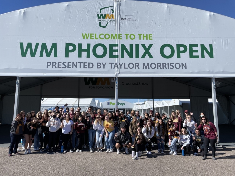 ASU events management students pose for a group photo at the TPC Scottsdale, site of the 2022 Waste Management Phoenix Open.