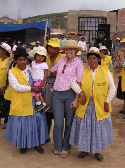 Professor posing with community workers in a rural setting.
