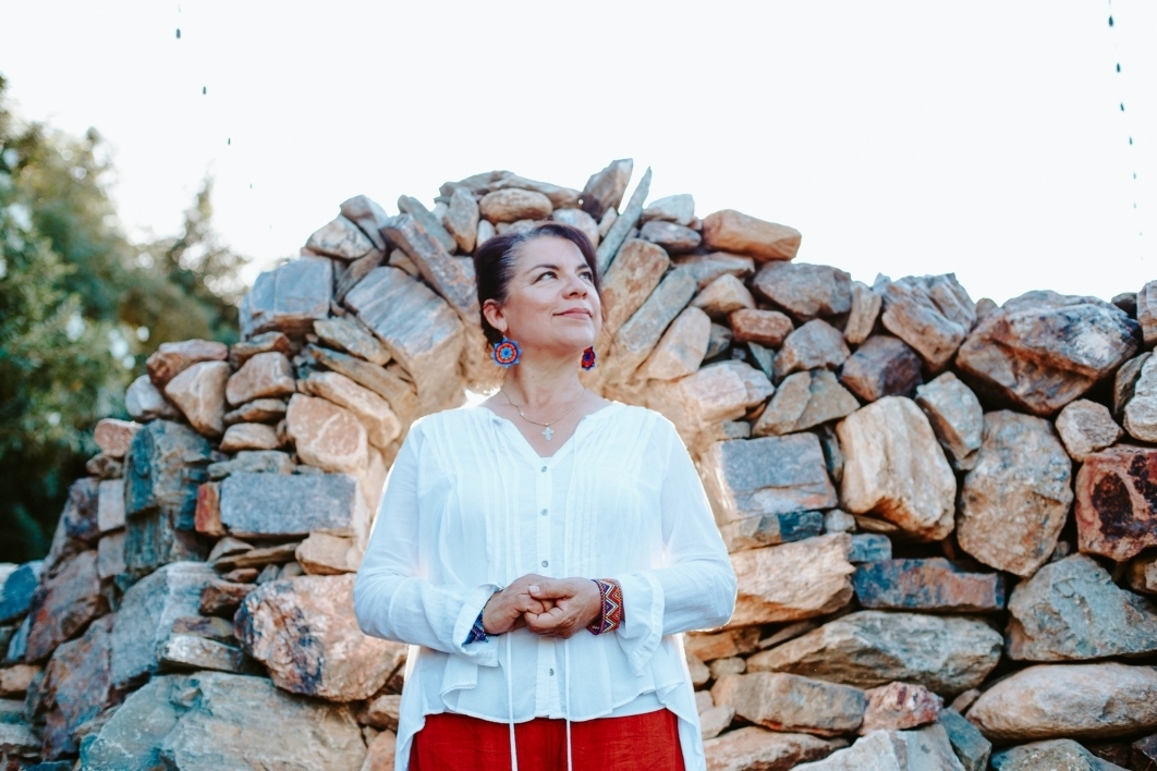 woman standing in front of rock formation