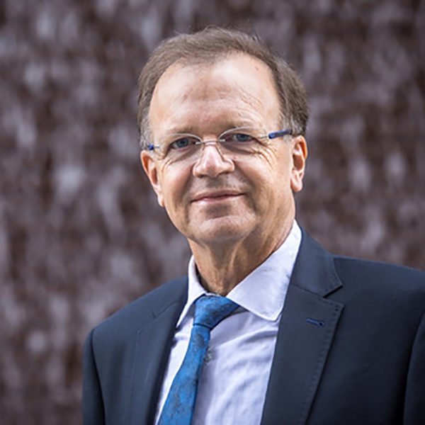 Man in glasses and suit smiling