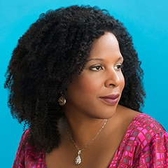 Portrait of Black woman with medium length dark, curly hair