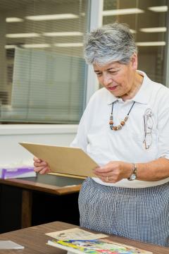 A woman looks at archival items at the library