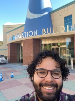 ASU alum Angel Ruvalcaba takes a selfie outside of the Disney Animation Building.