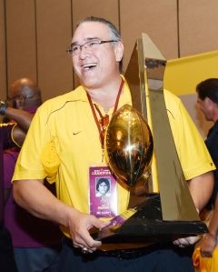 Man holding football trophy