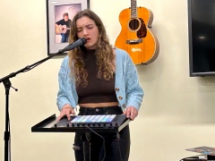 Student singing into mic while playing with soundboard