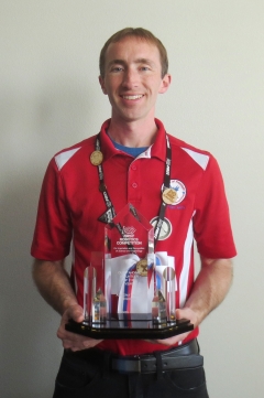 ASU Lecturer  holding a robotics award.