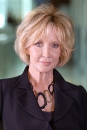Portrait of woman in black blazer with short blond hair