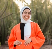 woman in headscarf and orange robe