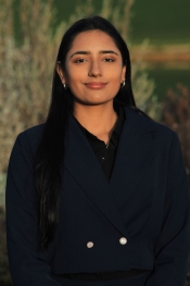 A headshot of a woman in a black coat.