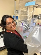 Dr. Bose mounting mm-sized Ryugu particles in an anaerobic chamber at the SLAC National Accelerator Facility. 