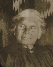 Black and white historical photo of a woman with white hair