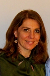 Photo of Banu Ozkan wearing a green shirt and her hair down to her shoulders