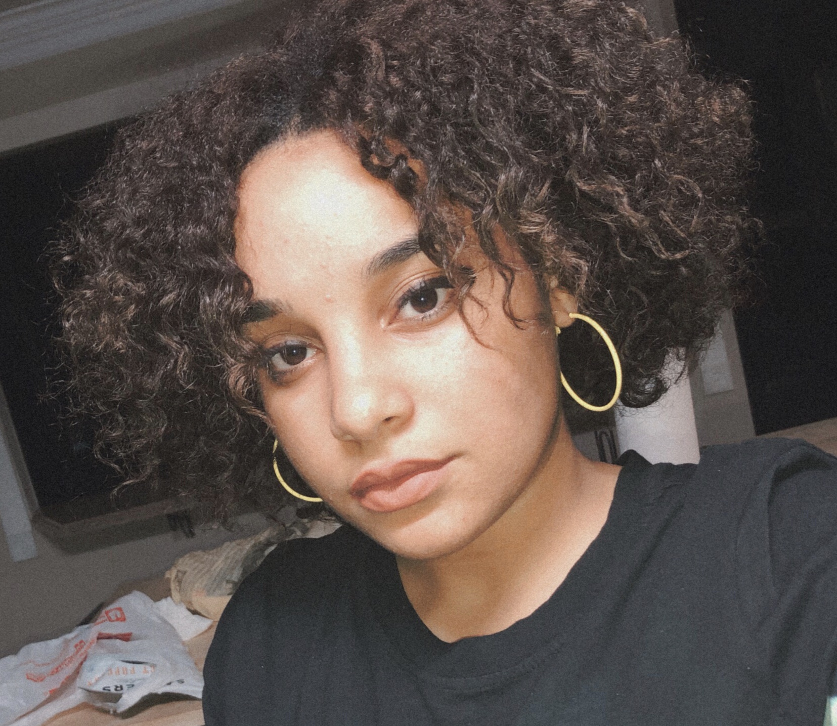 Woman with curly hair and earrinigs