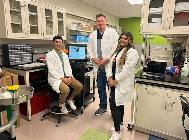 Vincent Truong poses with two undergraduate students who are learning about software created through a collaboration with the lab of Dr. Ulises Ricoy at the University of Arizona.