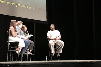 ASU 2023 Fall Welcome speaker, actor Winston Duke on stage with a panel of interviewers.