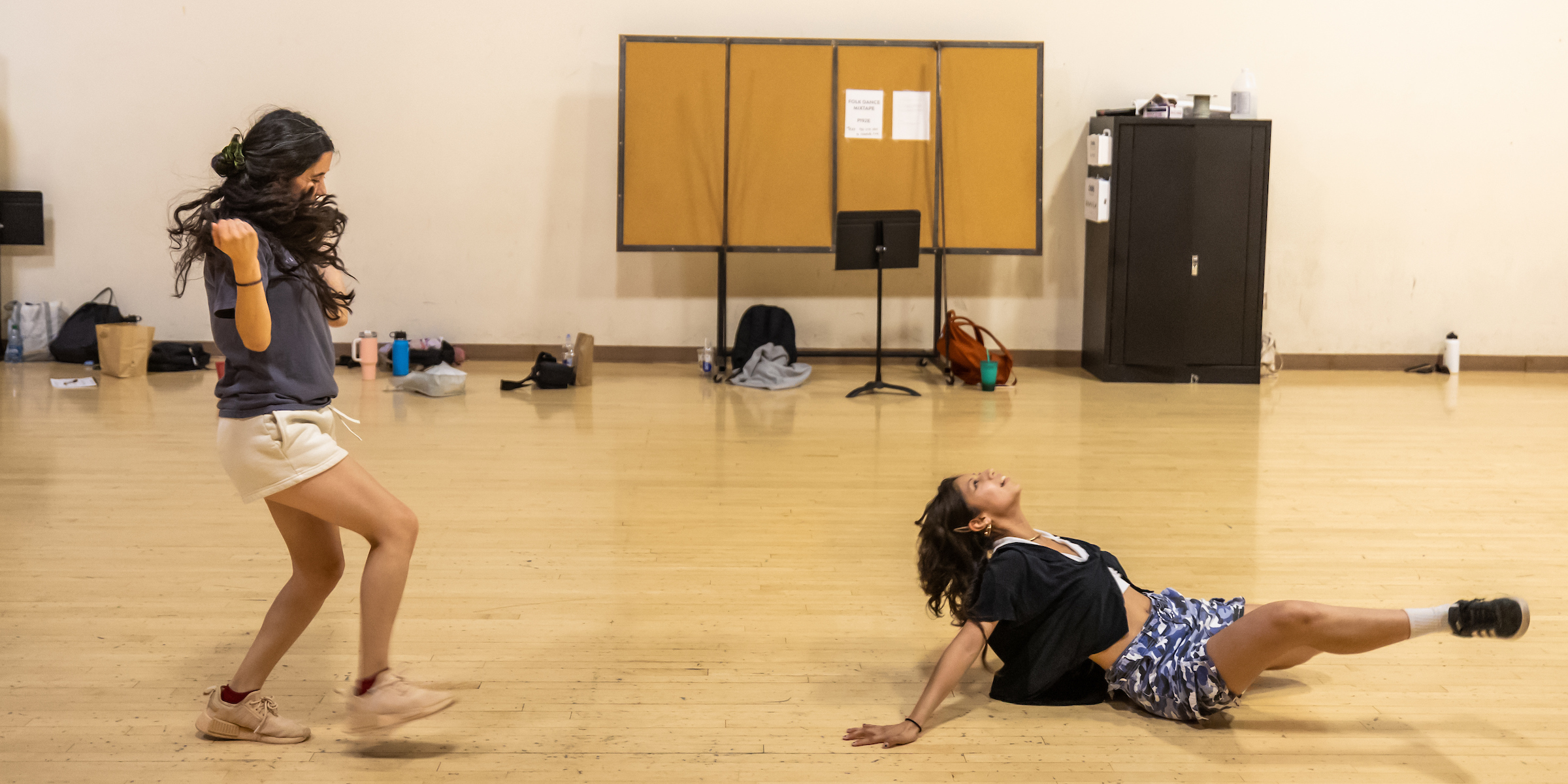 Two students performing hip hop dance in classroom