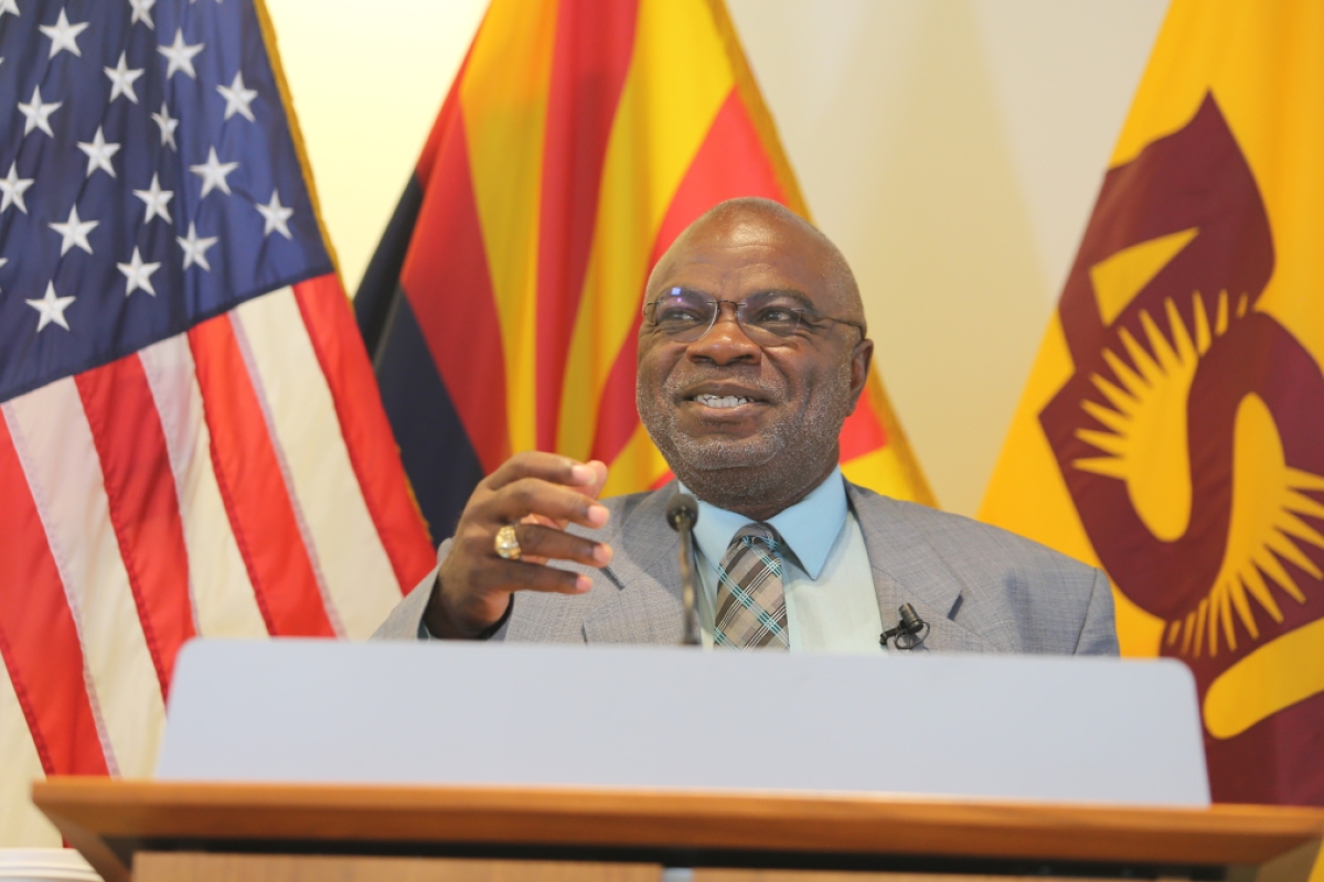 Man speaking behind a lectern.