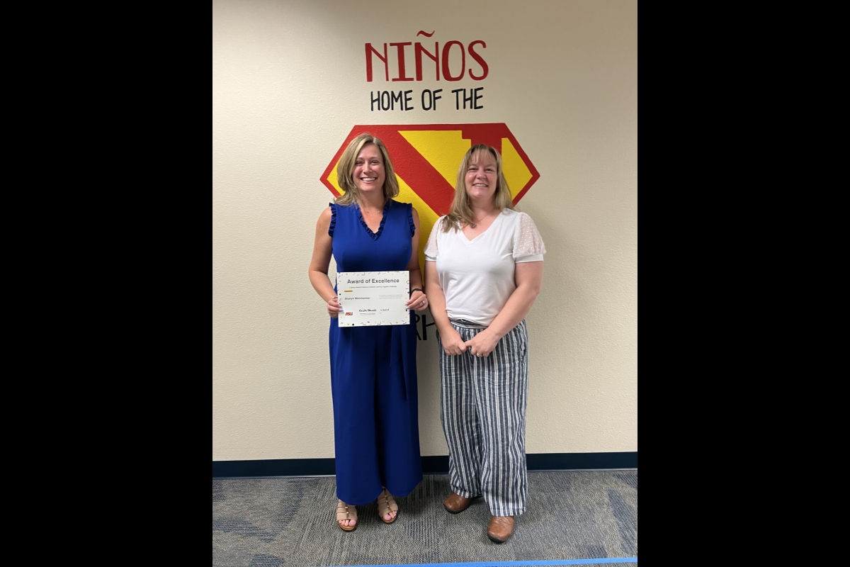 Teacher holding certificate for the Learning Together Challenge alongside project manager.