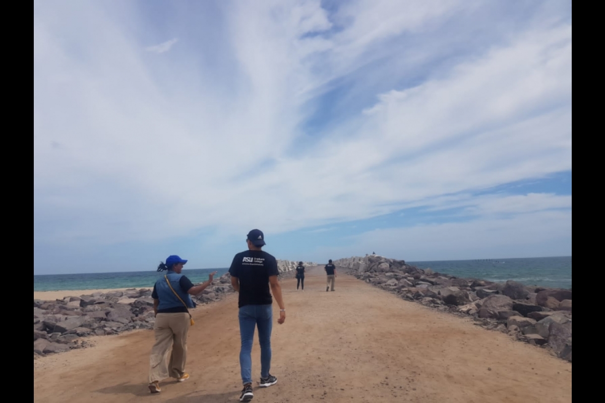 TEAM students and faculty walking on coastal pier