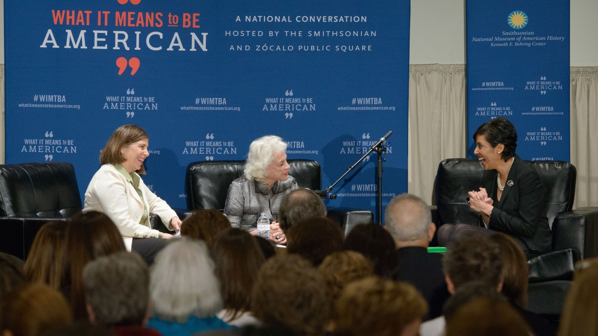 three women speak on stage during panel event 