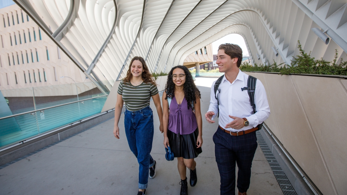 Students walking across the bridge over University Drive connected to ASU's Walton Center for Planetary Health