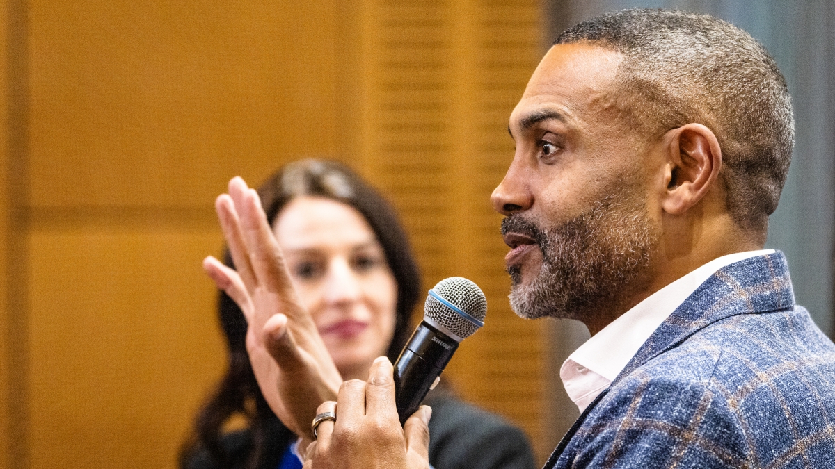Former NBA star Grant Hill speaking into a microphone.