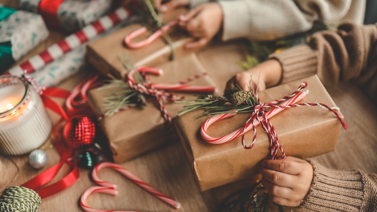 Hands wrapping Christmas presents.