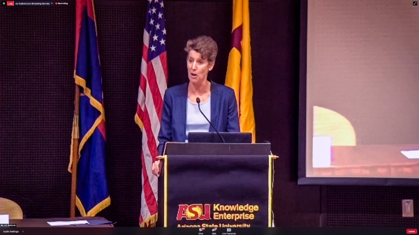 woman speaking at lectern