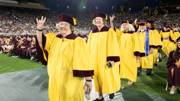 Golden Grads walking in Undergraduate Commencement