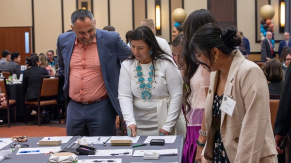 People looking at silent auction items