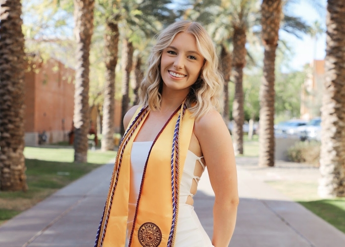 Portrait of ASU grad  on Palm Walk on the Tempe campus.