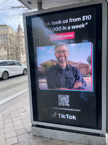 A TiKTok advertisement at a bus stop that features an Arizona entrepeneur